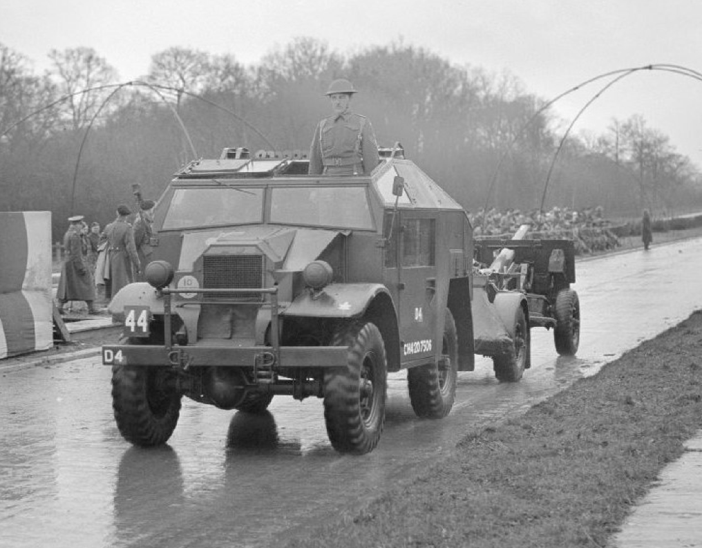 A field artillery tractor pulling
          a 25-pounder gun